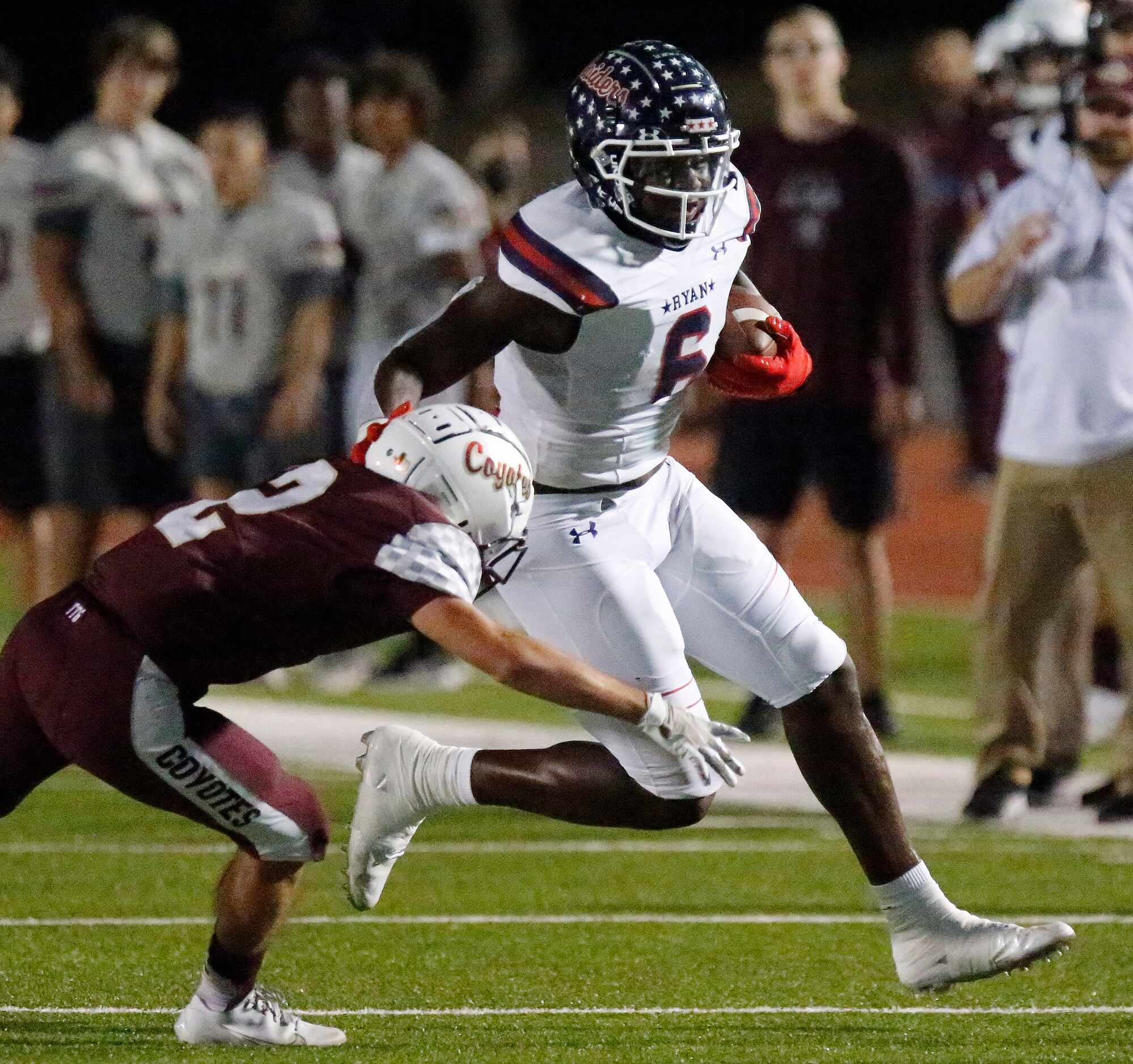 Denton Ryan High School running back Anthony Hill jr. (6) breaks a tackle attempt by Frisco...