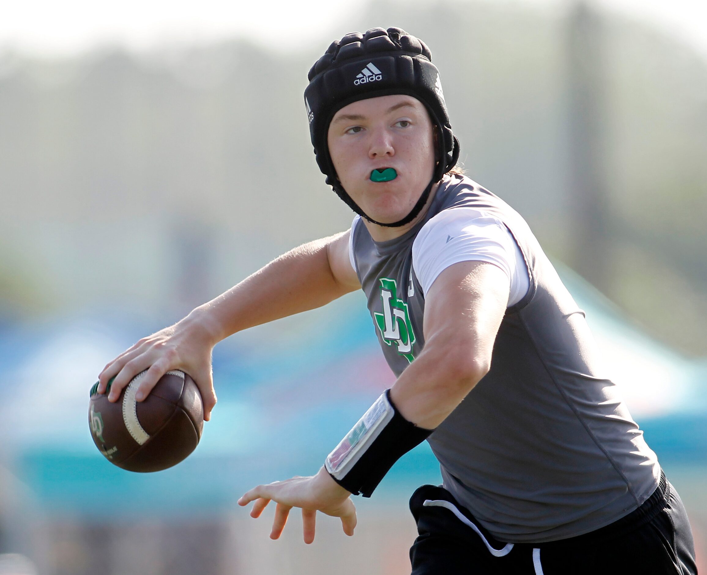 Lake Dallas quarterback Thomas Adams (9) prepares to launch a pass downfield during pool...