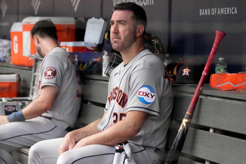Houston Astros starting pitcher Justin Verlander watches the game from the dugout in the...