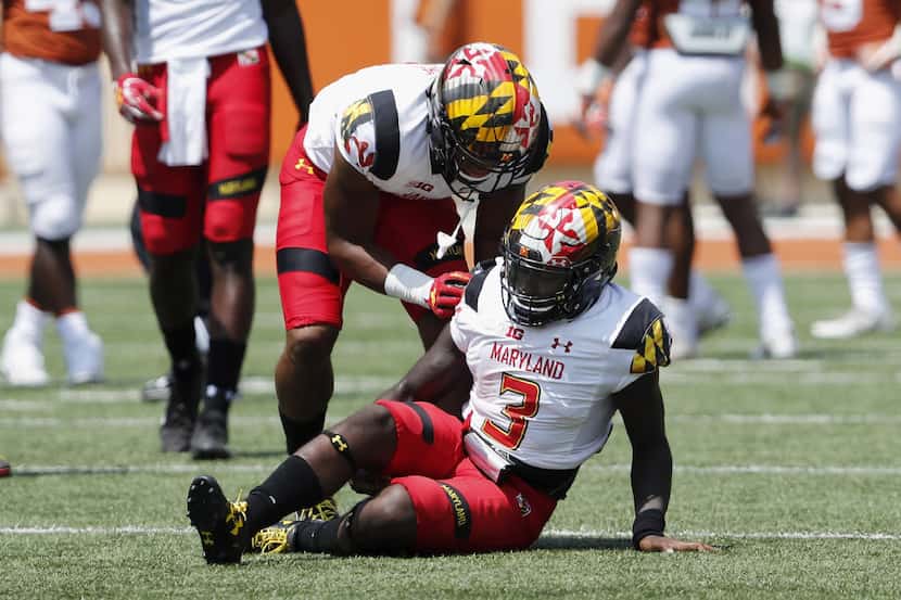 AUSTIN, TX - SEPTEMBER 02:  D.J. Moore #1 of the Maryland Terrapins tends to Tyrrell Pigrome...