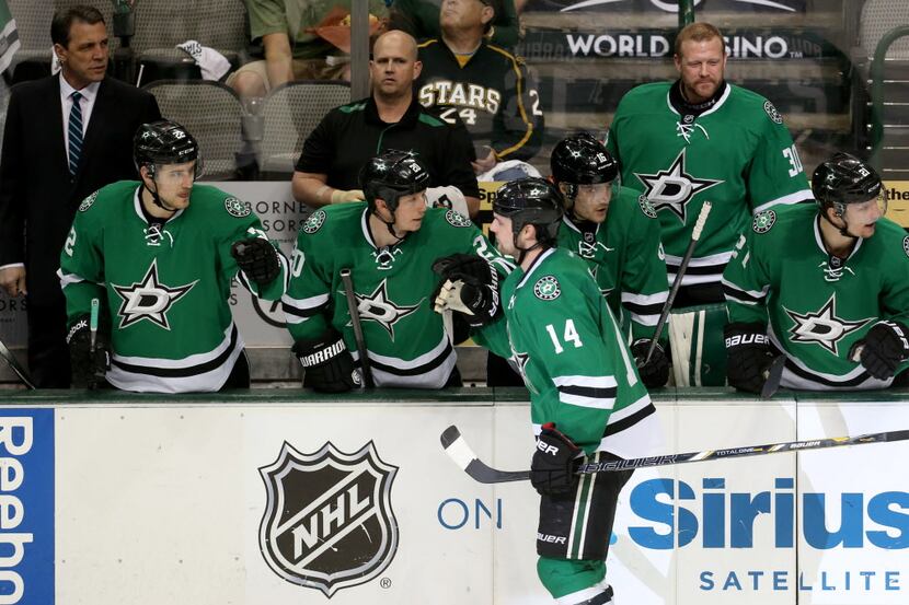 Dallas Stars left wing Jamie Benn (14) is congratulated by the bench after scoring against...