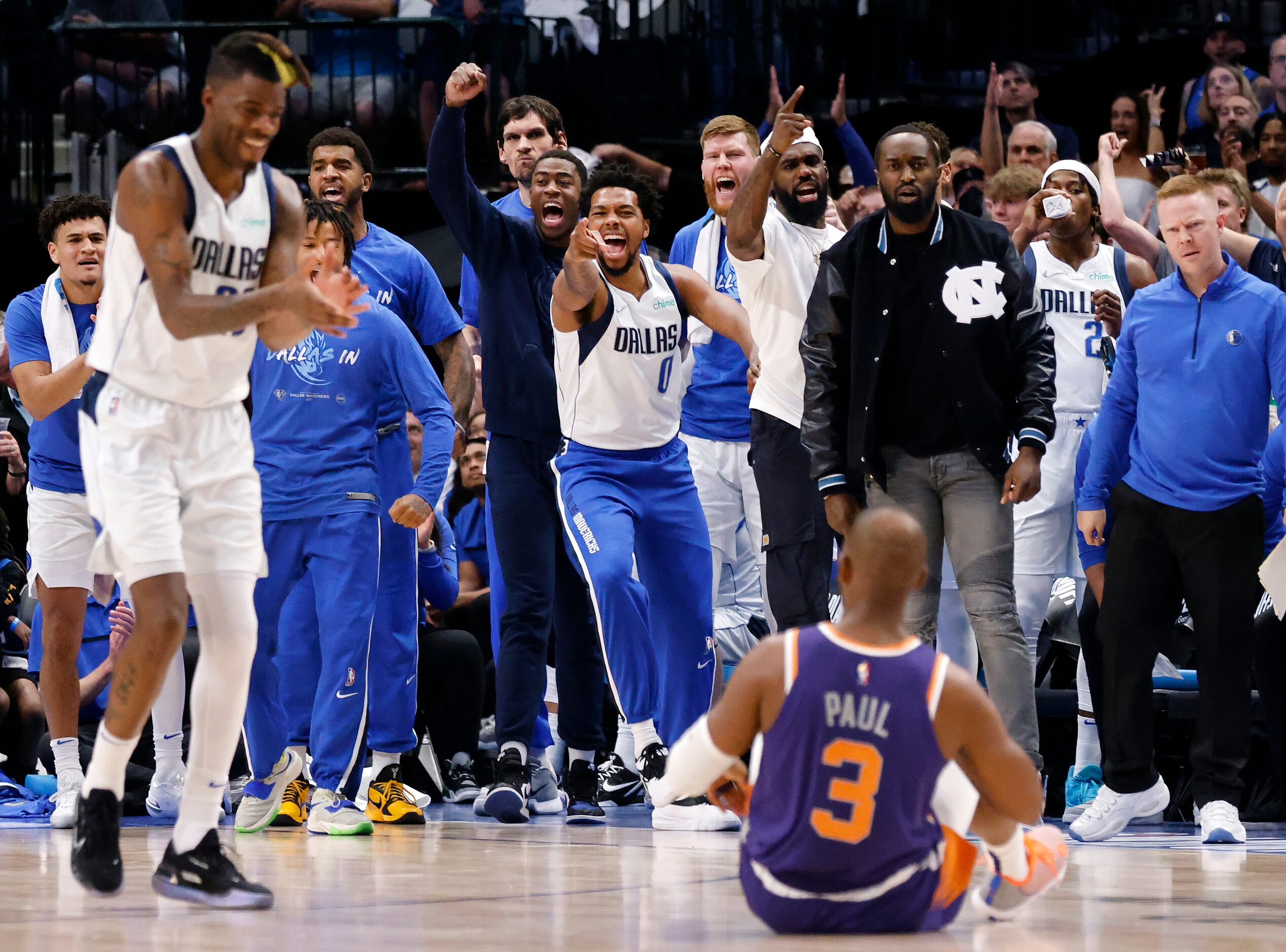 The Dallas Mavericks bench including forward Reggie Bullock (left) celebrate after Phoenix...