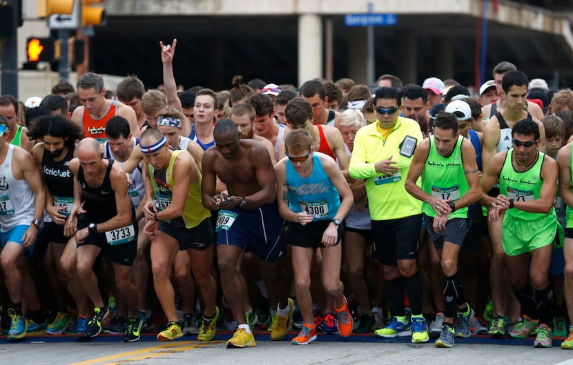 Runners begin at the start line at the Dallas YMCA Turkey Trot in downtown Dallas on Nov....