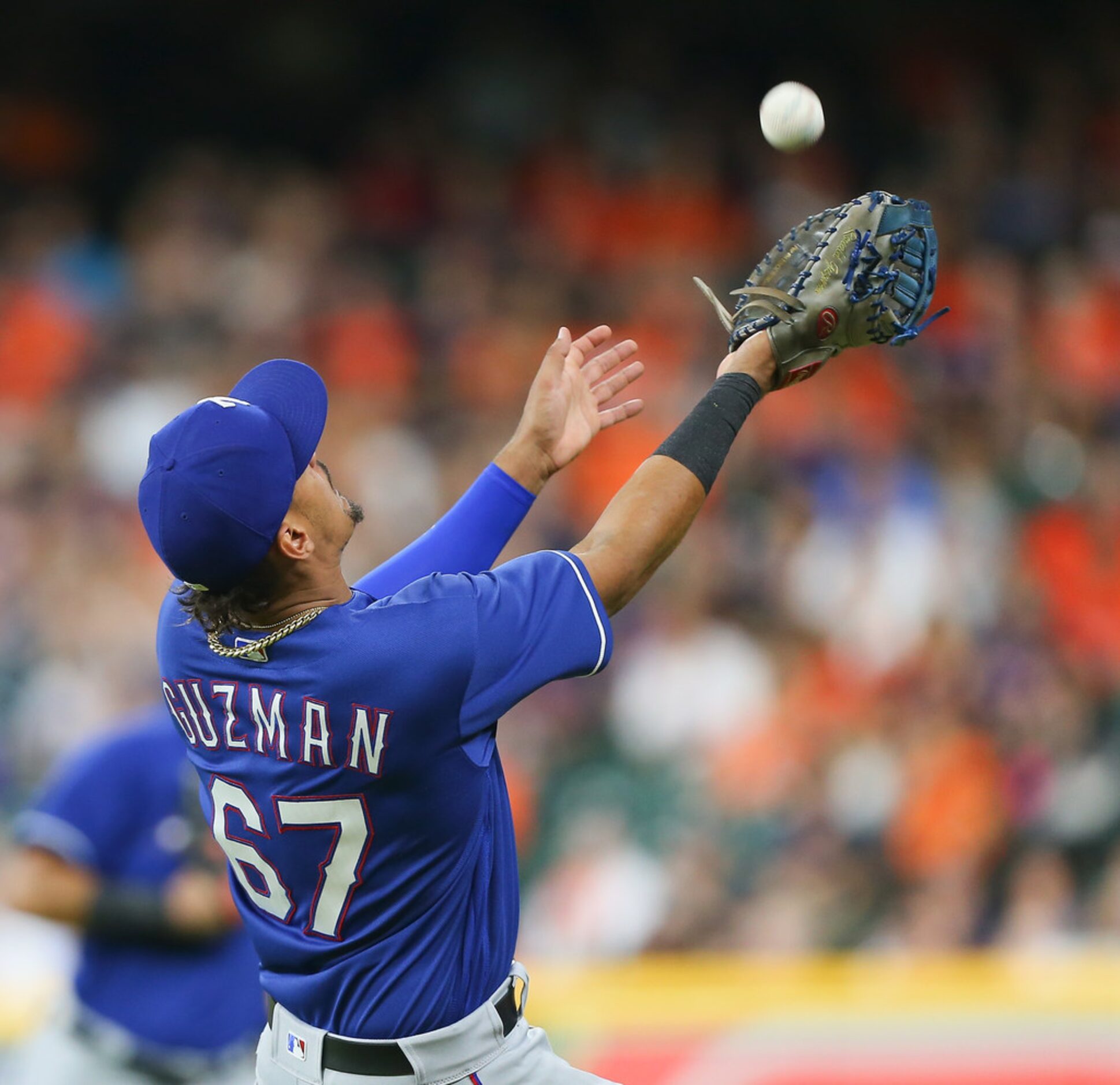 HOUSTON, TX - MAY 11:  Ronald Guzman #67 of the Texas Rangers makes a catch on a pop fly by...