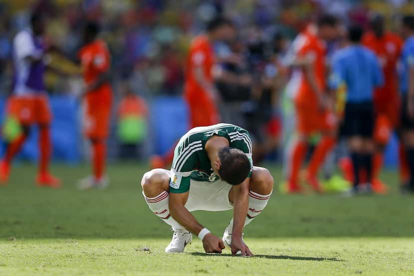 Mexico's Javier Hernandez punches the ground after the Netherlands defeated Mexico 2-1 to...