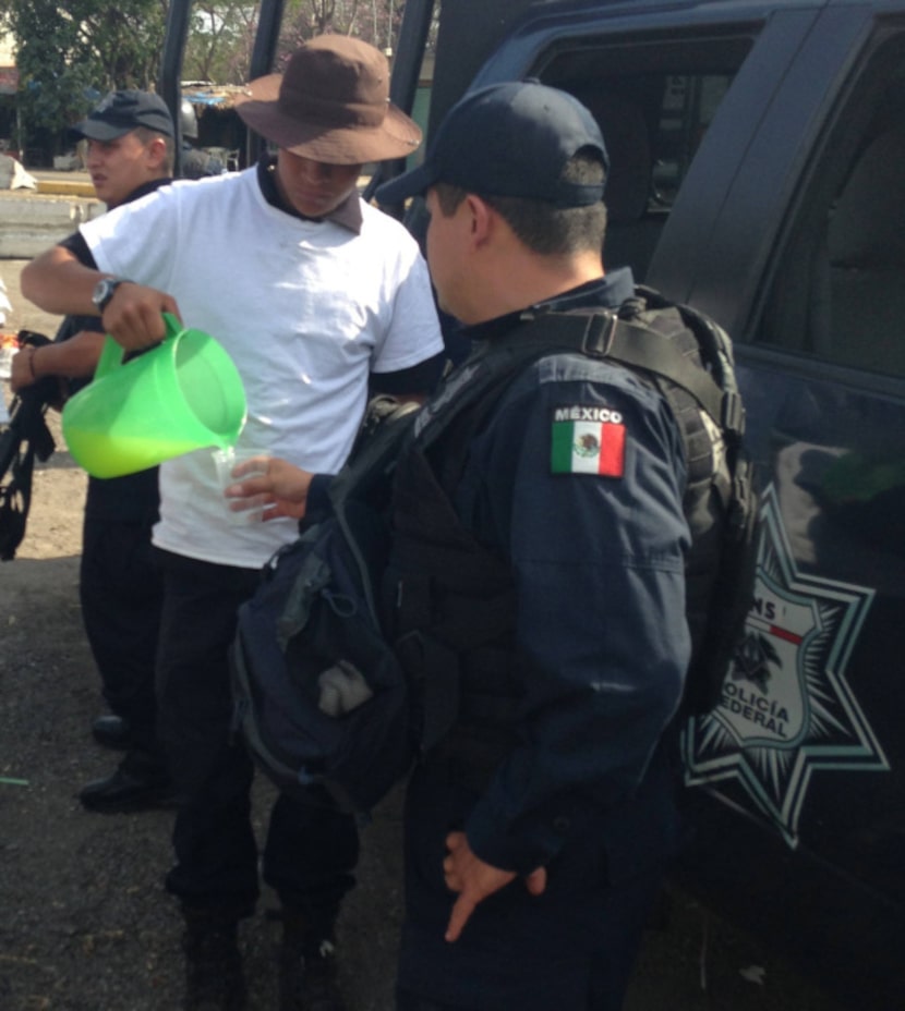 Leonardo Quintero, a member of a local self-defense force, pours lemonade for a federal...