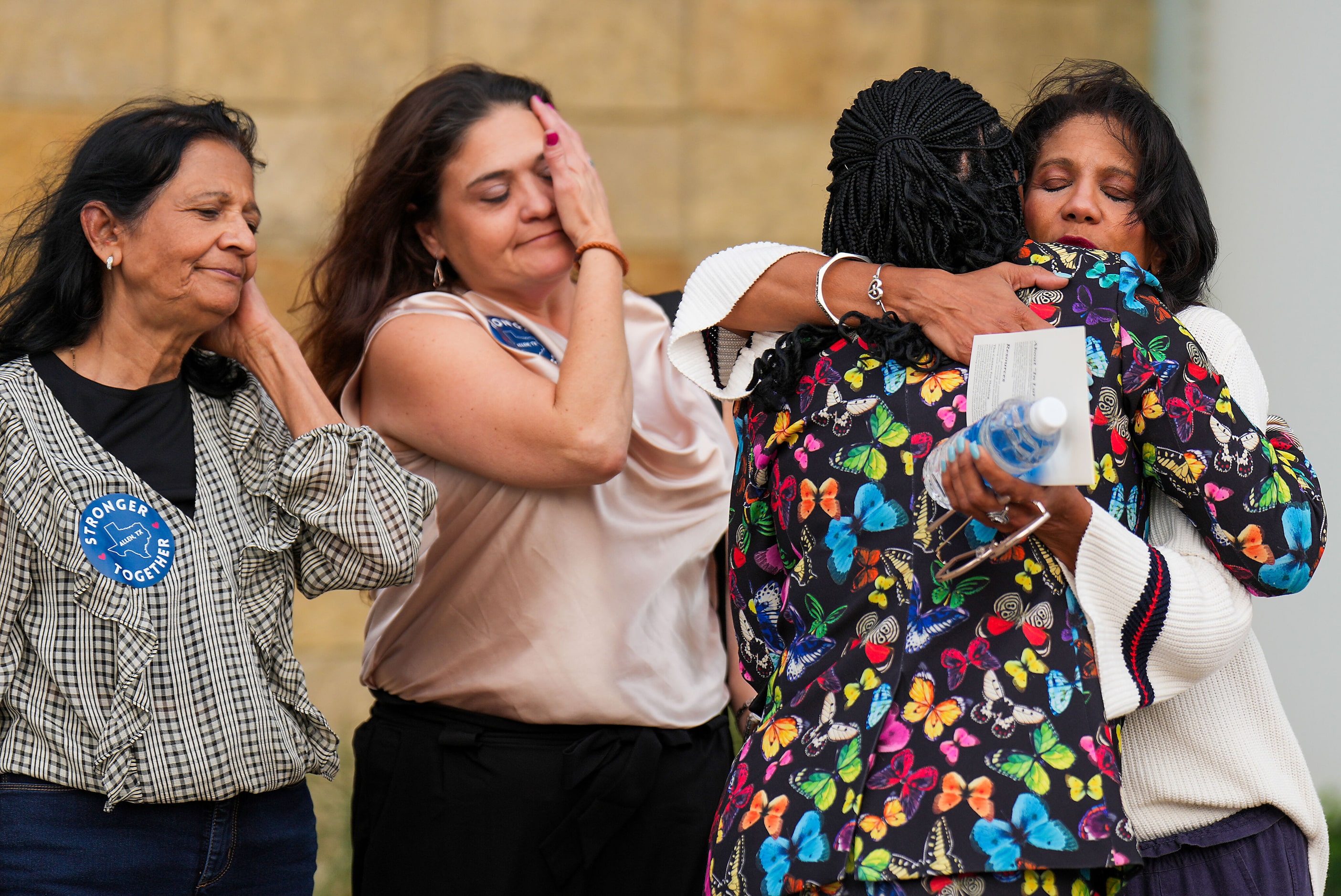 Inga Van Wagoner (facing) hugs Cheryl Jackson after a remembrance event at Credit Union of...