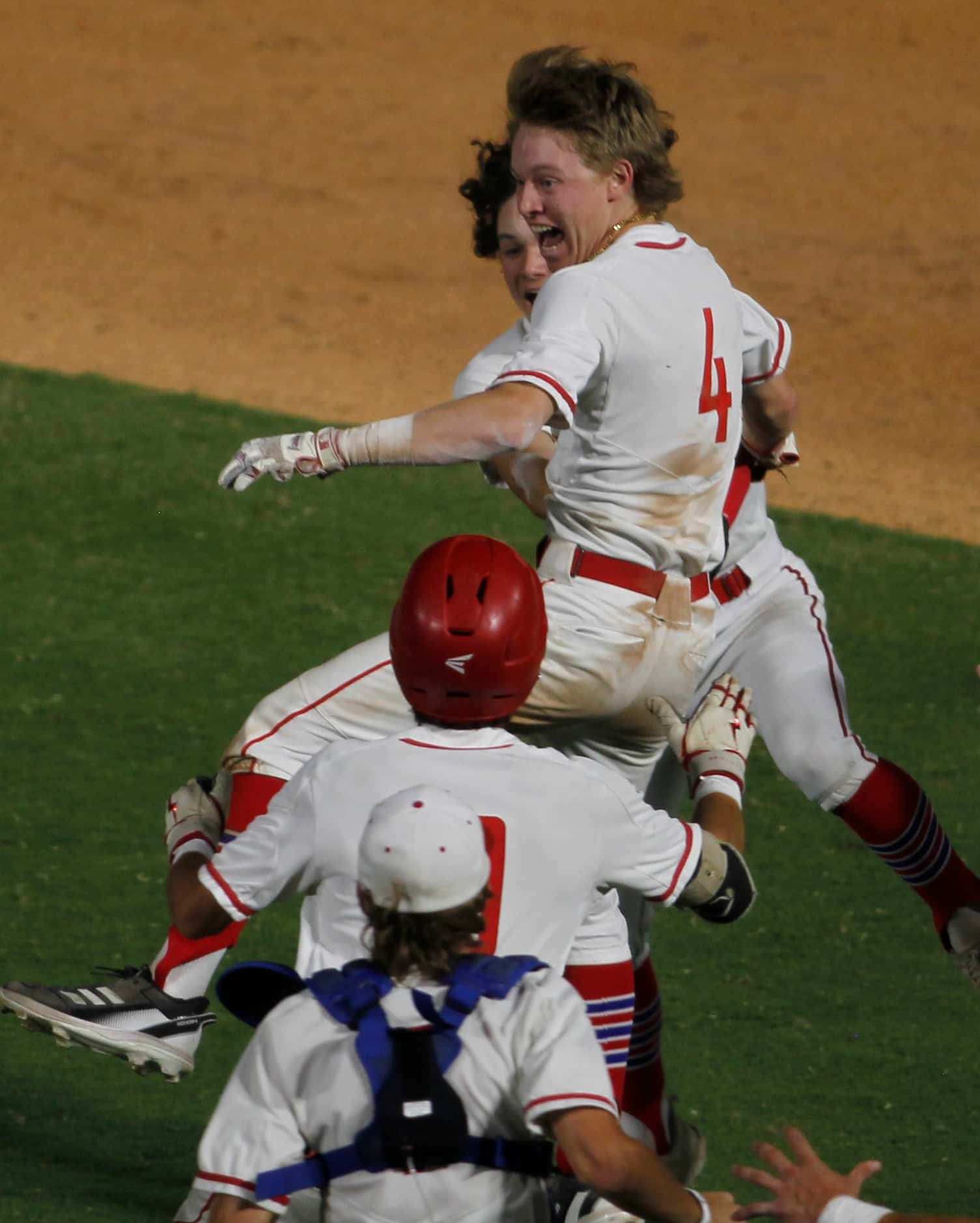 Grapevine shortstop Brenton Lee (4) celebrates with teammates after their 2-1...