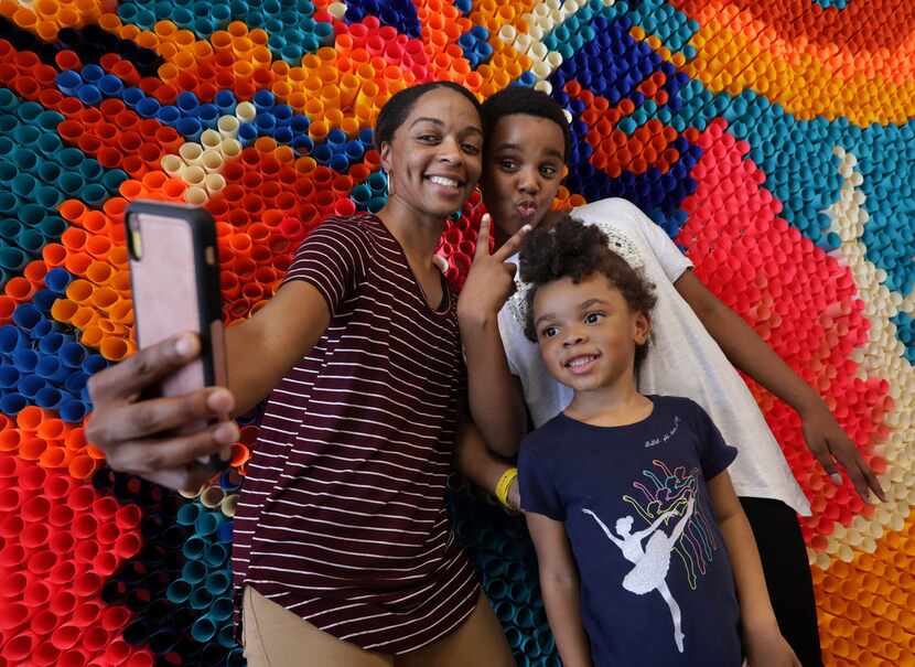 Philicia Carter-Blue, left, takes a photograph of 11-year-old Ja'Nihya Carter-Blue, and...