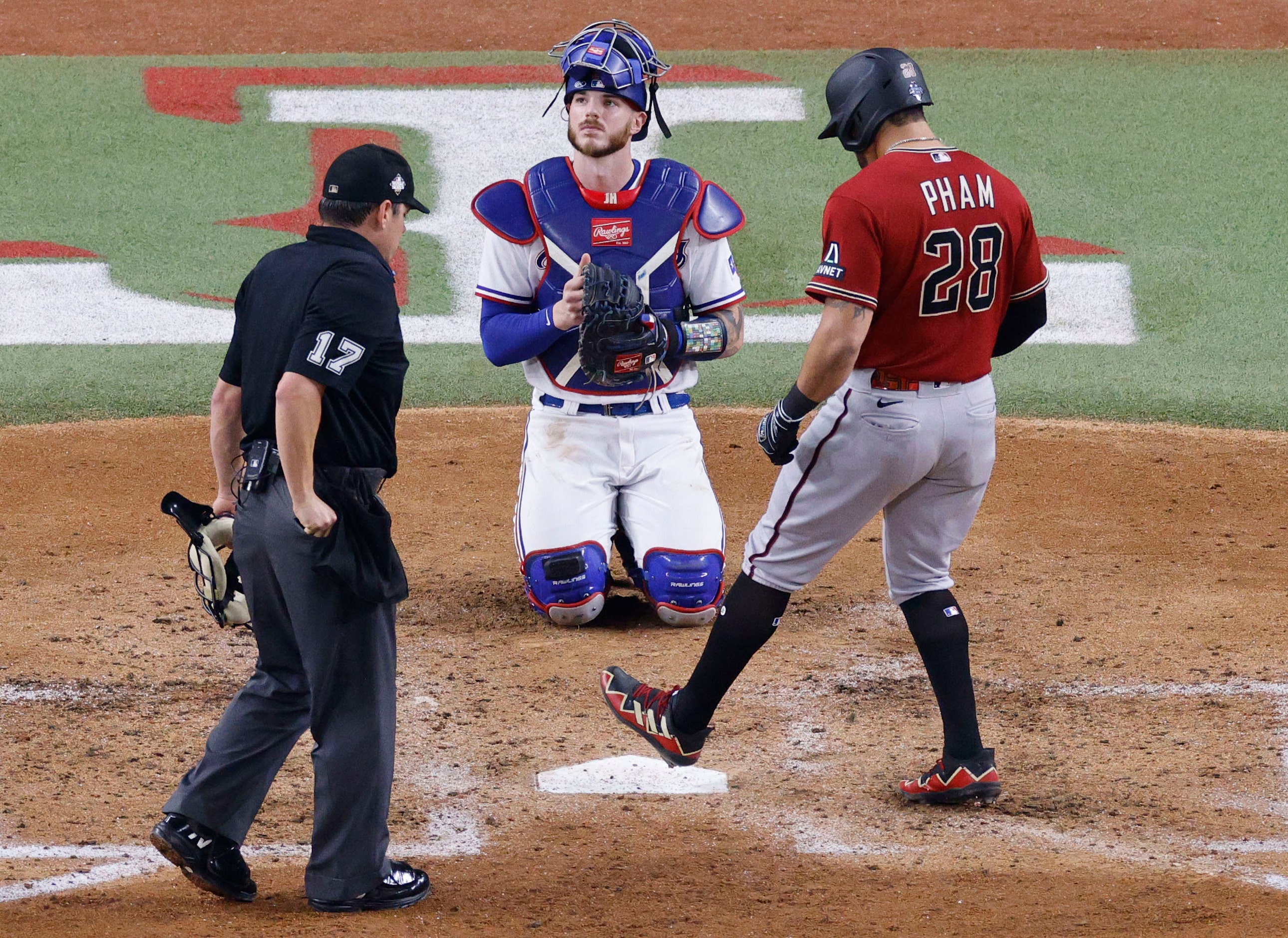 Texas Rangers catcher Jonah Heim (28) looks away when Arizona Diamondbacks left fielder...