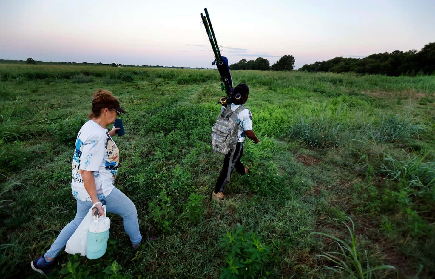 In search for their fishing spot, Odell Allen and his wife Beverly Rasnick hike through high...