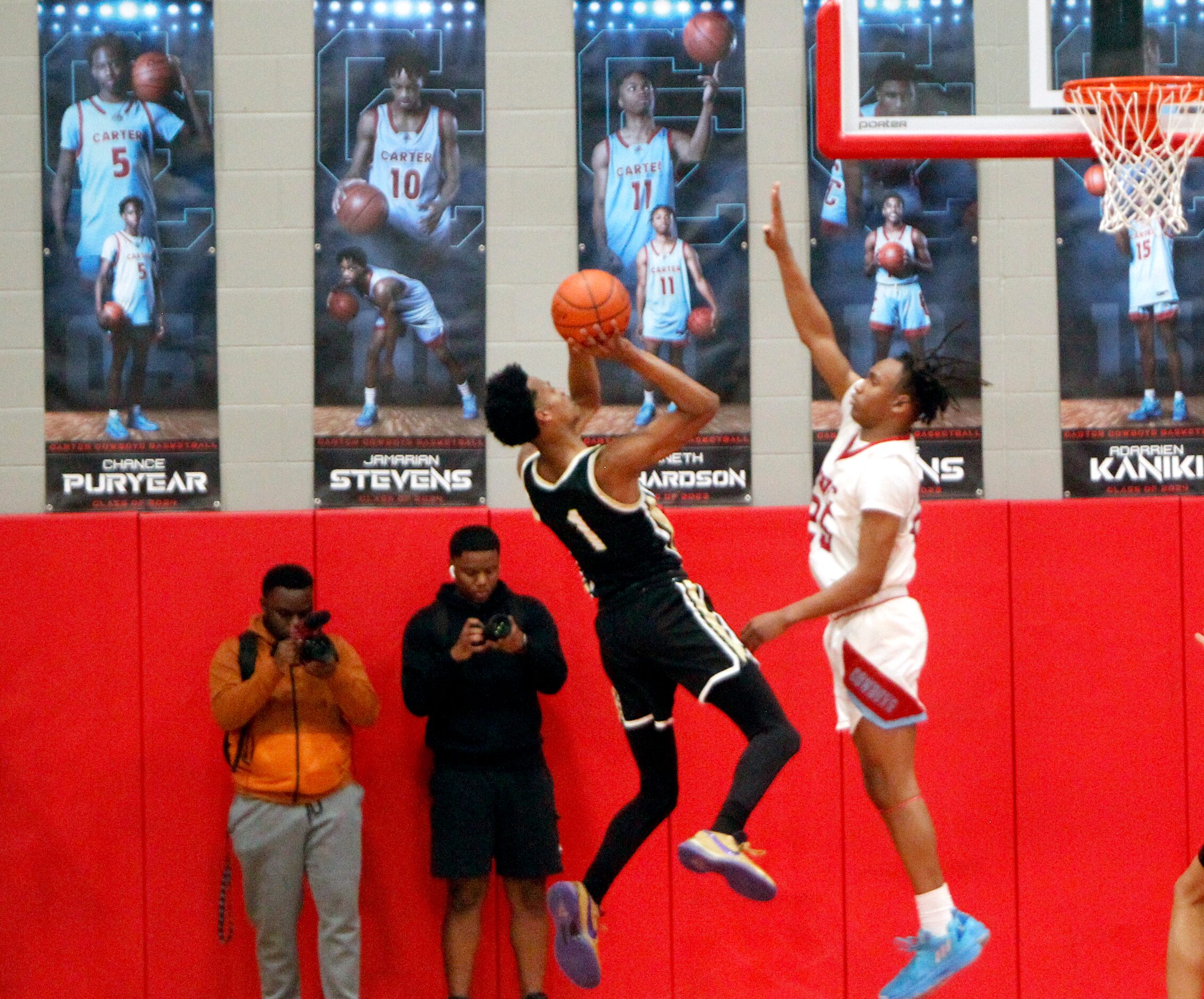 Dallas Pinkston's Dink Pate (1) gets off a jump shot in front of Dallas Carter guard Kole...