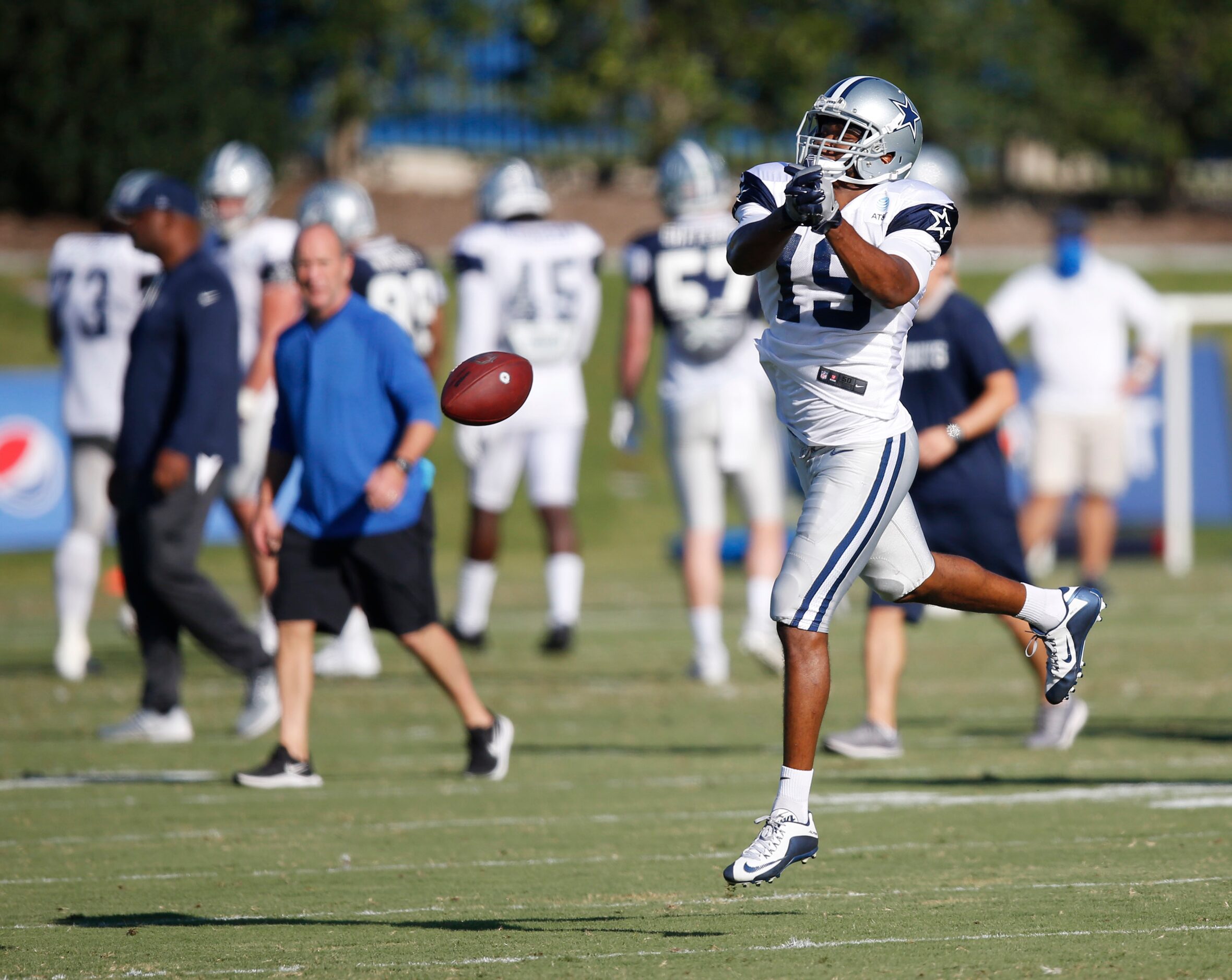 Dallas Cowboys wide receiver Amari Cooper (19) misses the catch in practice during training...