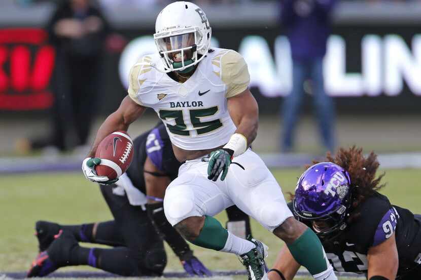 Baylor running back Lache Seastrunk (25) breaks away from TCU defender Mike Tuaua (93) on a...