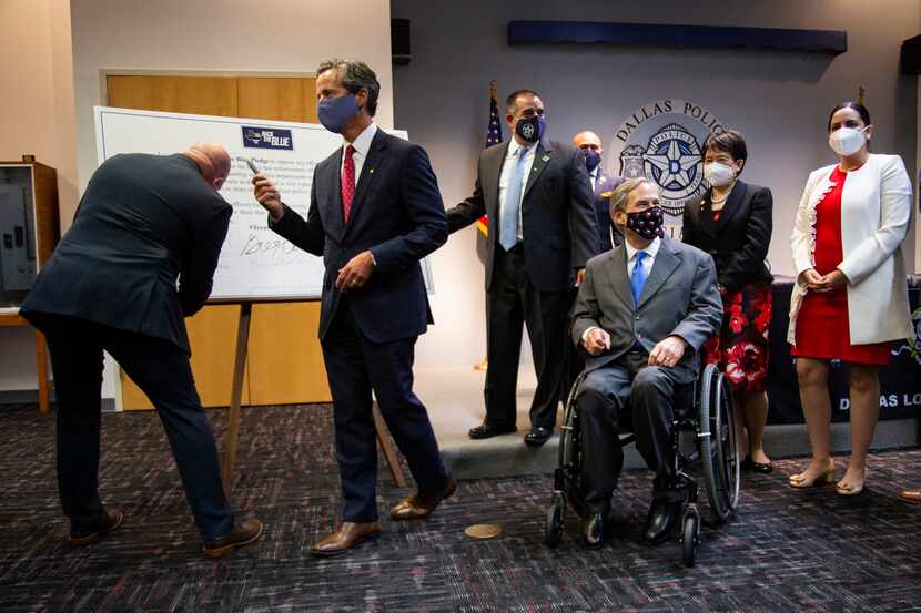 Governor Greg Abbott waits as local elected officials sign a Back the Blue Pledge after a...