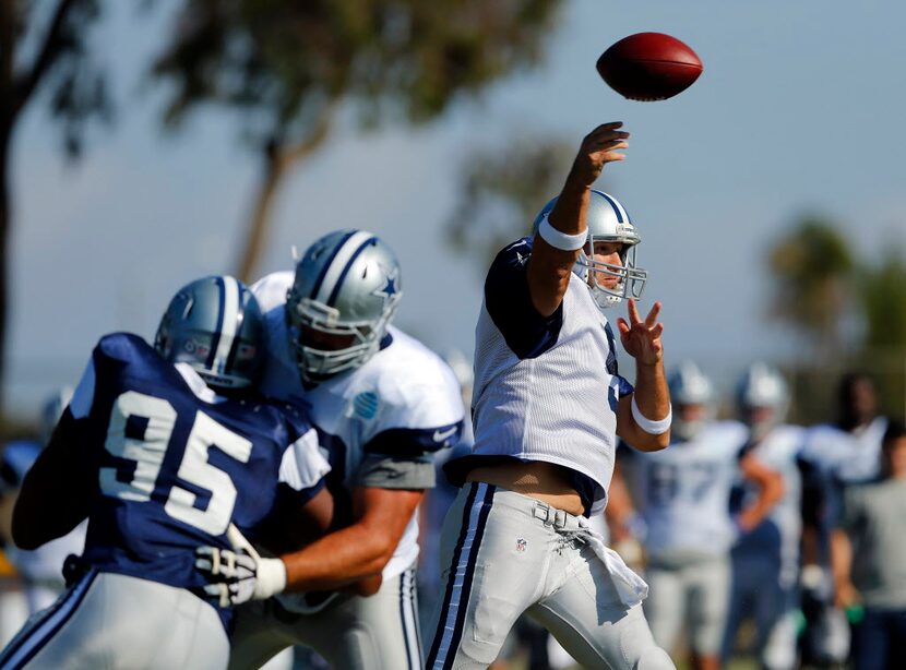 Dallas Cowboys quarterback Tony Romo (9) releases a pass during afternoon practice at...