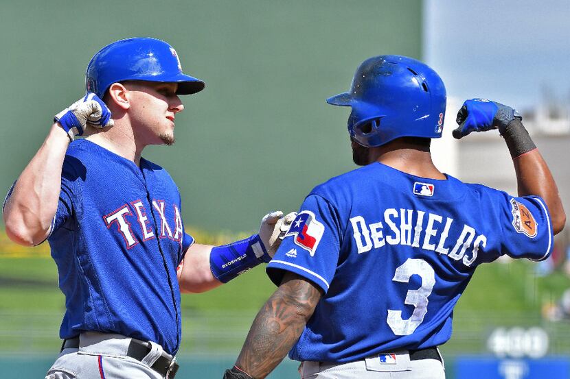 Texas Rangers' Delino DeShields congratulates Ryan Rua after Rua's first inning, two-run...