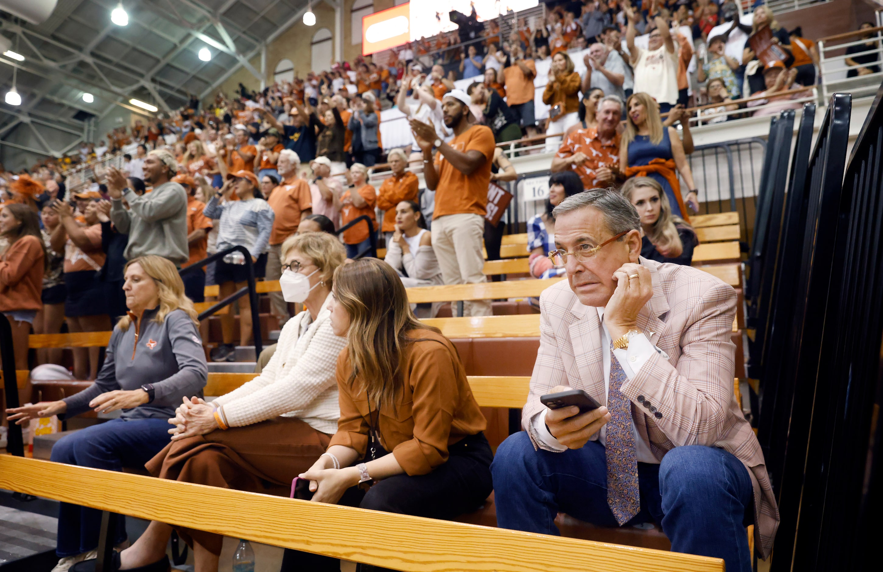 University of Texas Athletic Director Chris Del Conte (right) reacts as Missouri takes the...