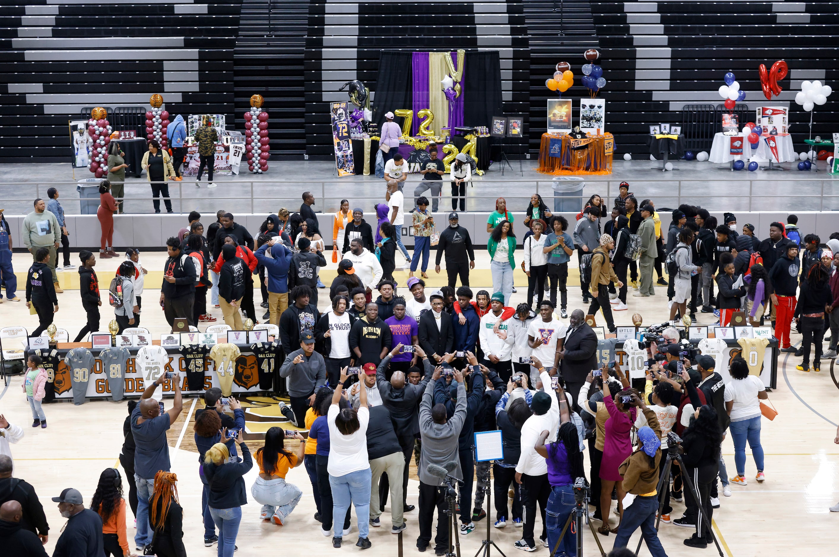 South Oak Cliff football players gathered to pose for photos following the national letter...