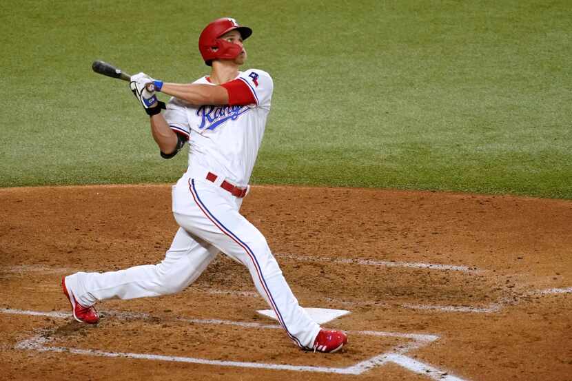 Texas Rangers' Corey Seager watches an RBI sacrifice fly against the Seattle Mariners during...