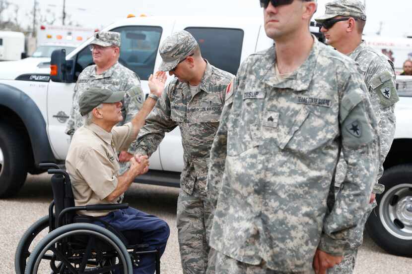 Gov. Greg Abbott shakes hands with National Guardsmen after Hurricane Harvey hit Rockport....