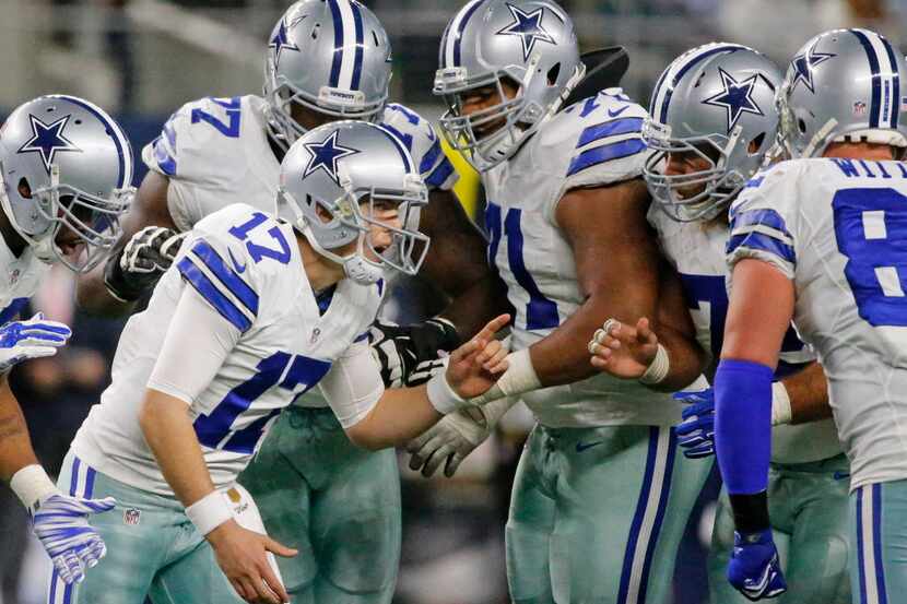 Dallas Cowboys quarterback Kellen Moore (17) calla the play in the huddle in the second...