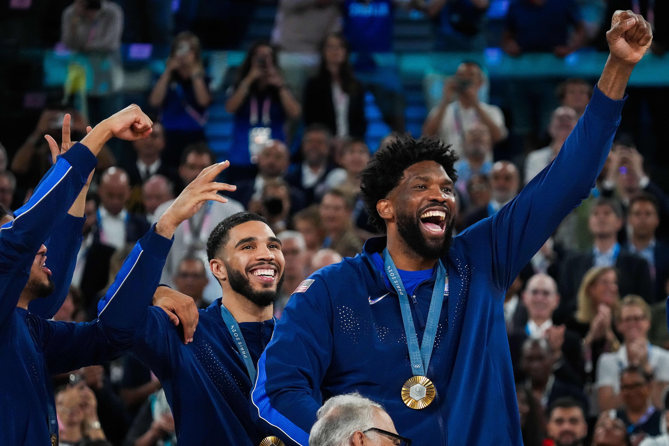 Joel Embiid of the United States celebrates on the medals podium after a victory over France...