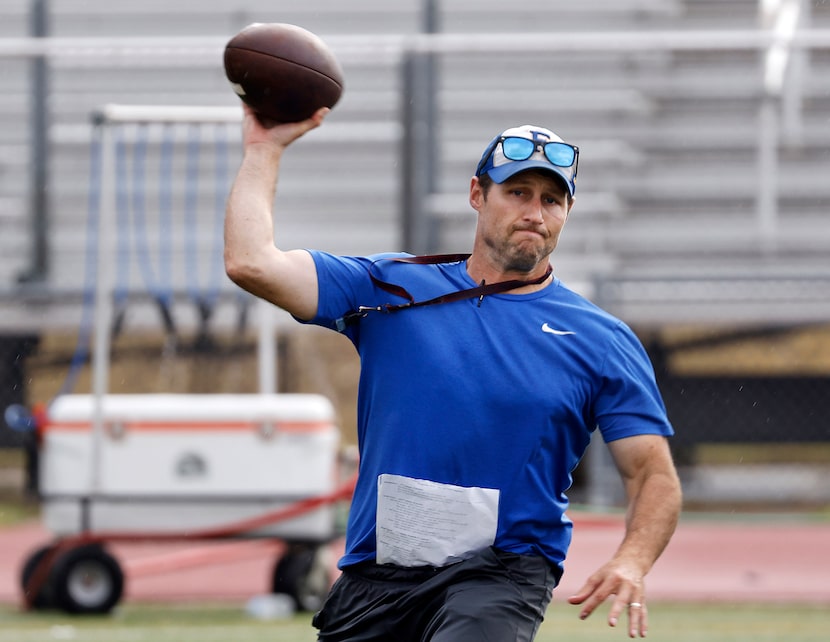 Frisco High head football coach Jeff Harbert throws a pass to a player as he fills in as...