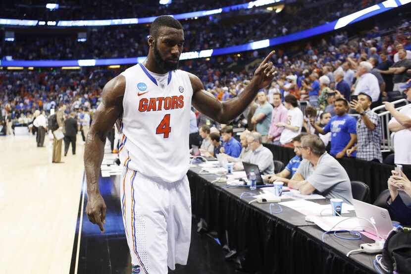 Florida center Patric Young (1) signals the number one to the fans after after the Gators...