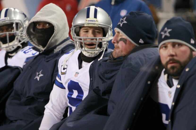 Dallas Cowboys quarterback Tony Romo (9) talks on the bench with Dallas Cowboys tight end...