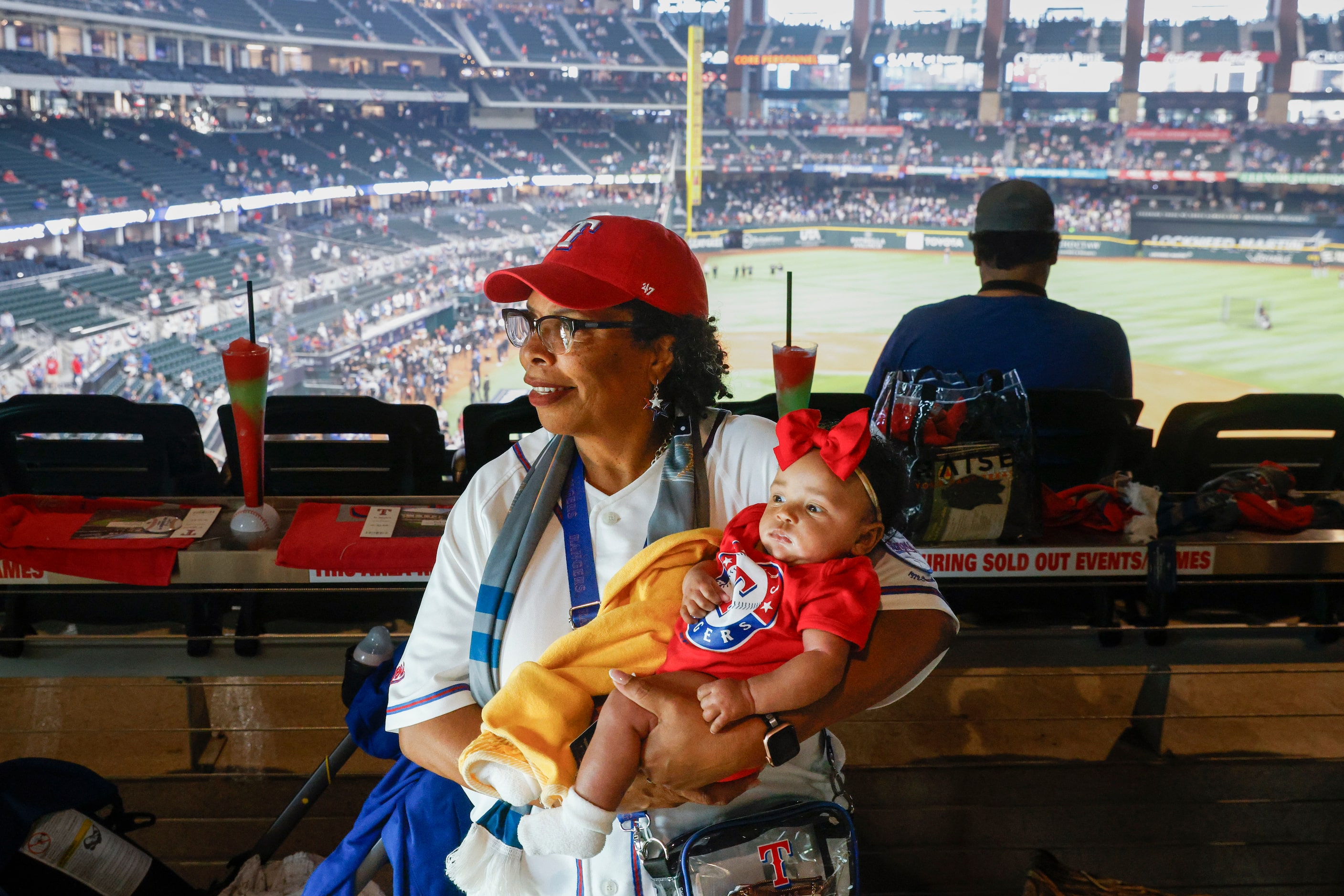 Dr. Pat Lewis carries her granddaughter Peyton Johnson at Globe Life Field prior to Game 1...