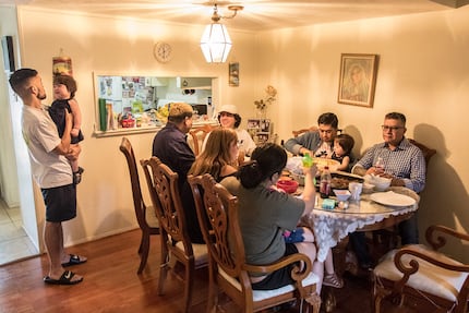 Family members of Jesus Jimenez, a copy editor at The Dallas Morning News, eat barbacoa...