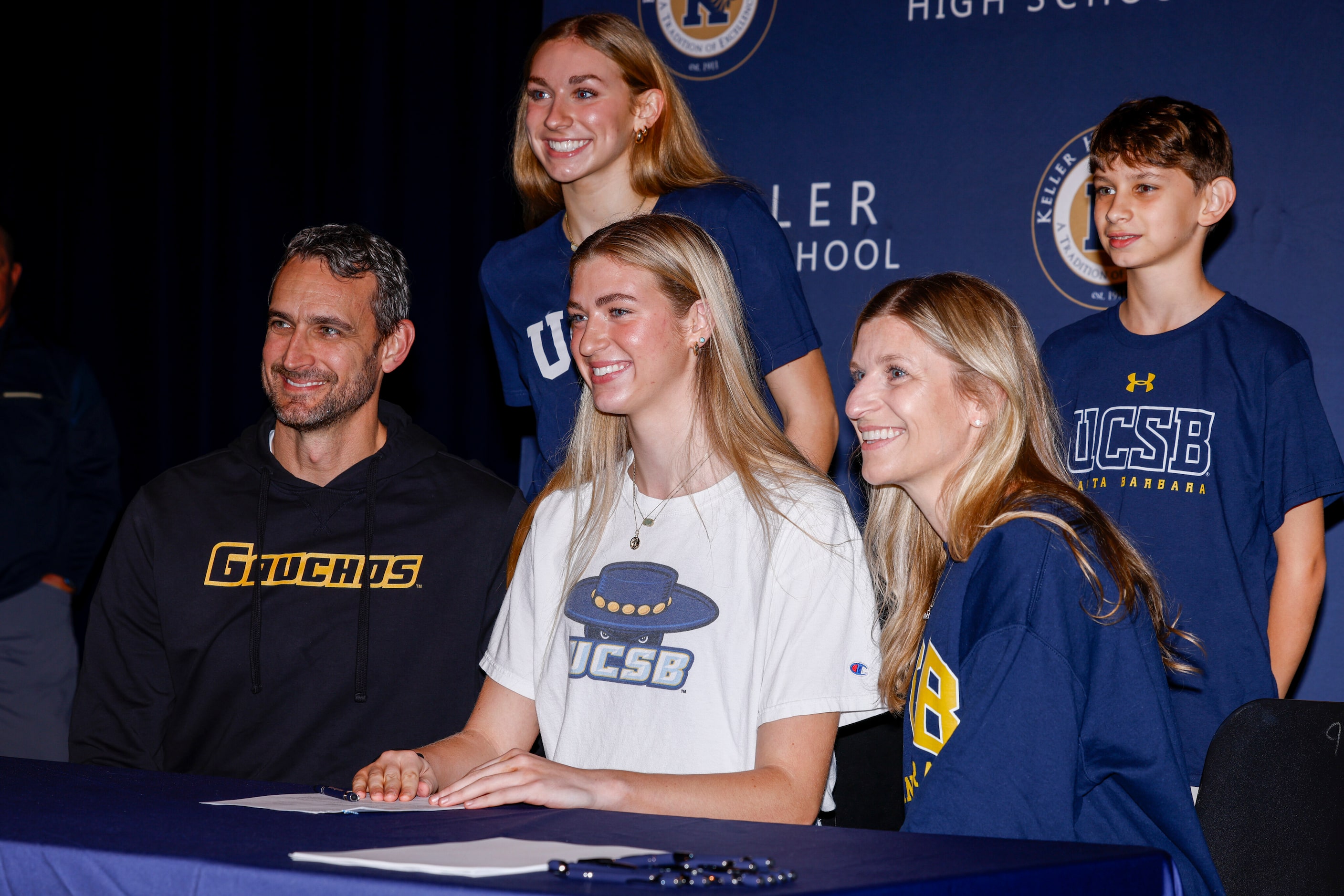 Keller volleyball player Anna Boater (center) poses for photos with her family during a...