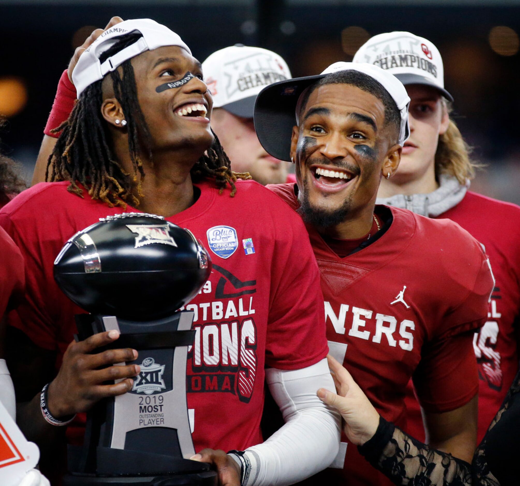 Oklahoma Sooners quarterback Jalen Hurts (right) congratulators wide receiver CeeDee Lamb on...