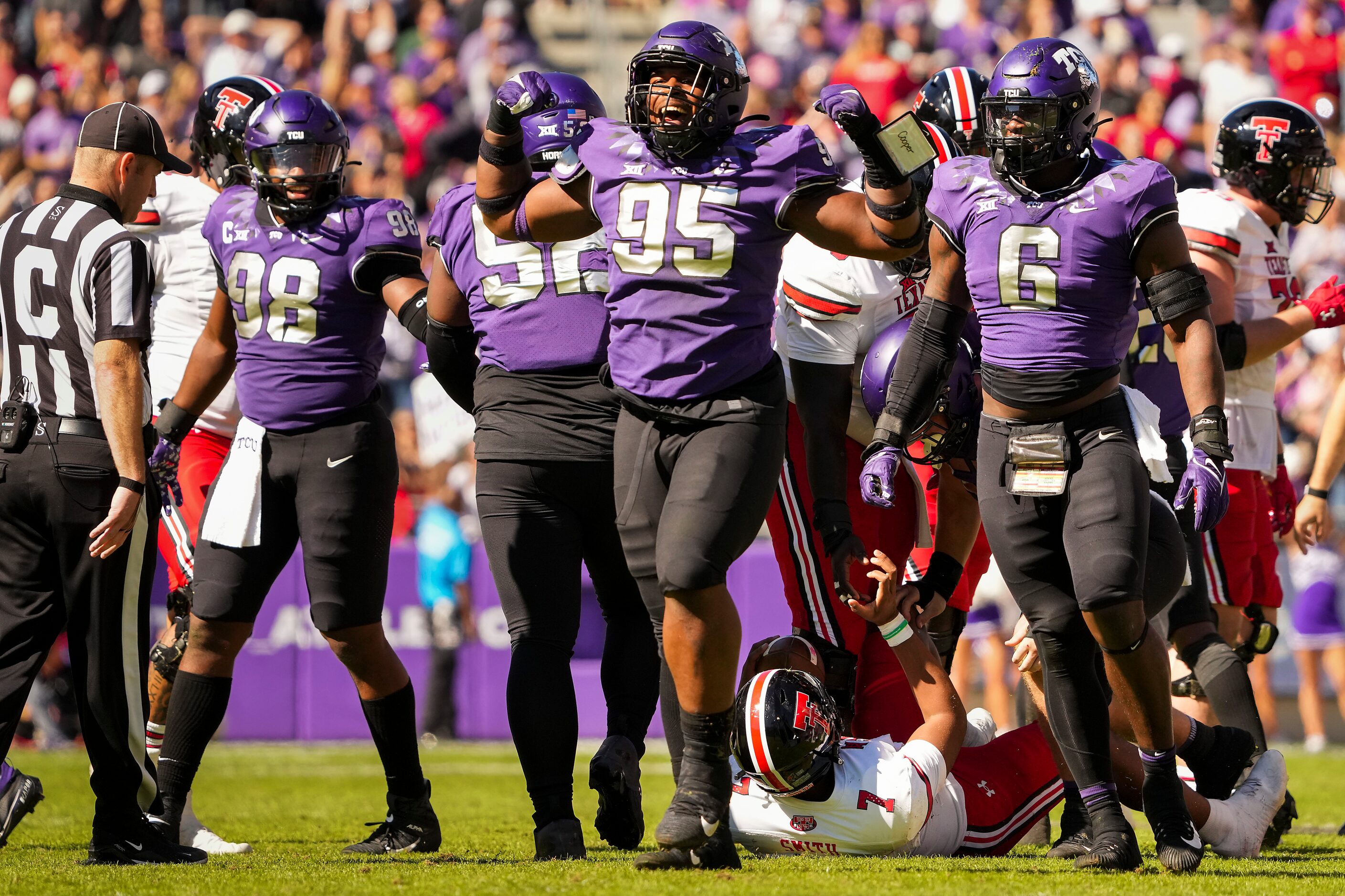 TCU defensive lineman Terrell Cooper (95) celebrates with teammates after stopping Texas...