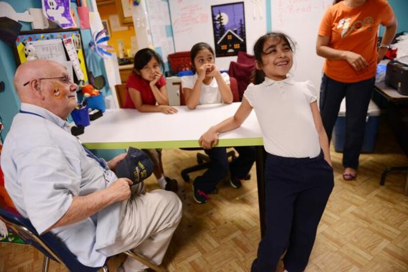 
Bob Jagers, 91, a World War II Navy veteran and author, jokes around with Ana Rocha, 7,...