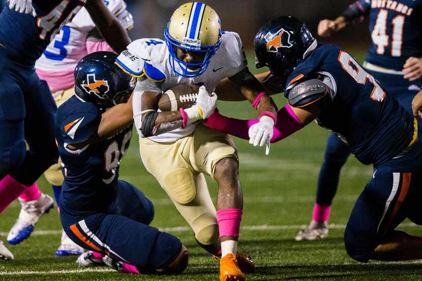 Garland Lakeview running back Camar Wheaton (4) was tackled by Sachse defensive linemen Ryan...