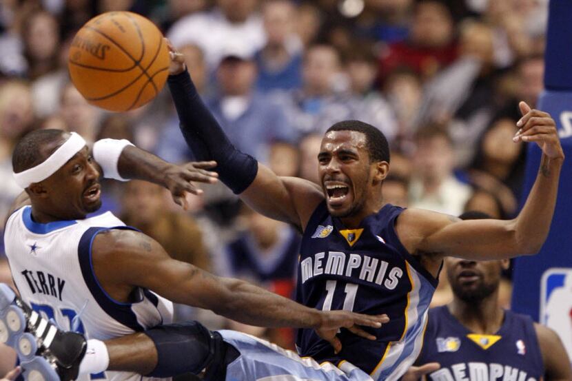 Grizzlies point guard Mike Conley (11) is fouled by Mavericks shooting guard Jason Terry...
