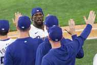 Texas Rangers outfielder Adolis García (53) gets high-fives after their 7-2 victory against...