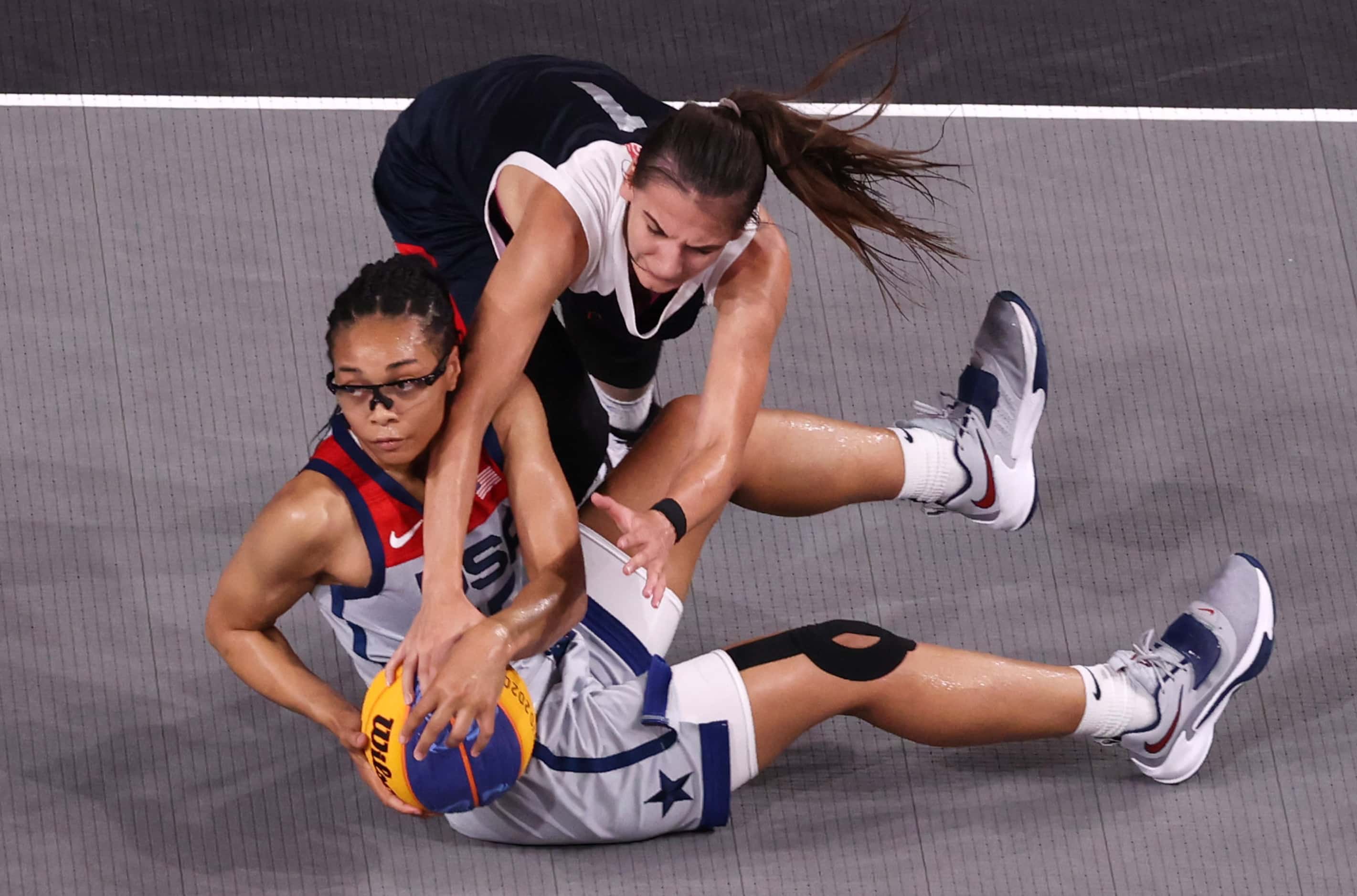 USA’s Allisha Gray (15) and ROC’s Yulia Kozik (1) get tied up with the ball during the 3x3...