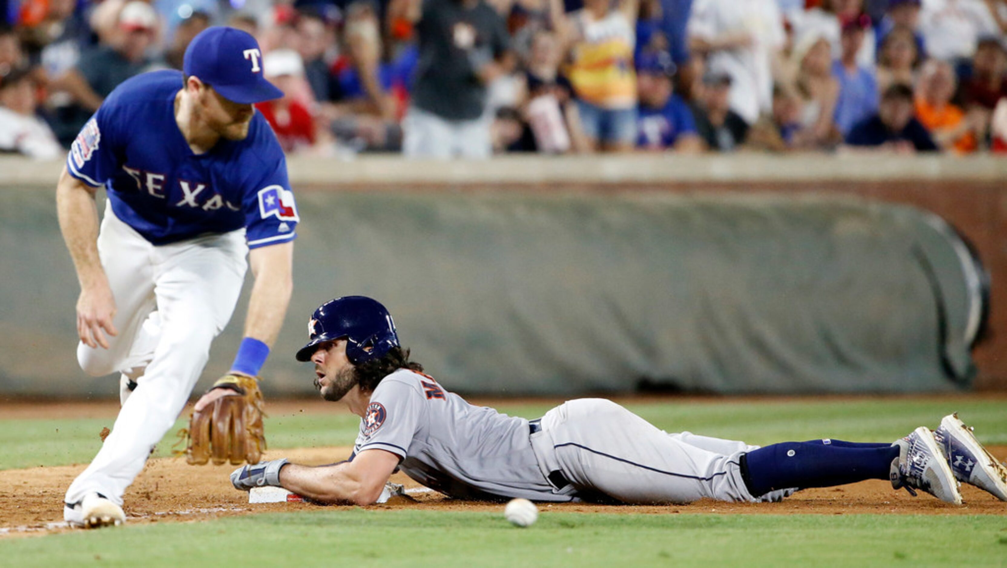 Houston Astros center fielder Jake Marisnick (6) slides safely into third base after hitting...