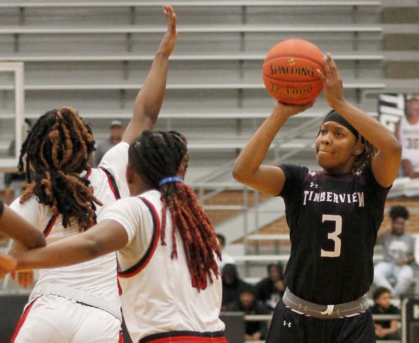 Mansfield Timberview point guard Desiree Wooten (3) sinks a 3-pointer over the defense of...