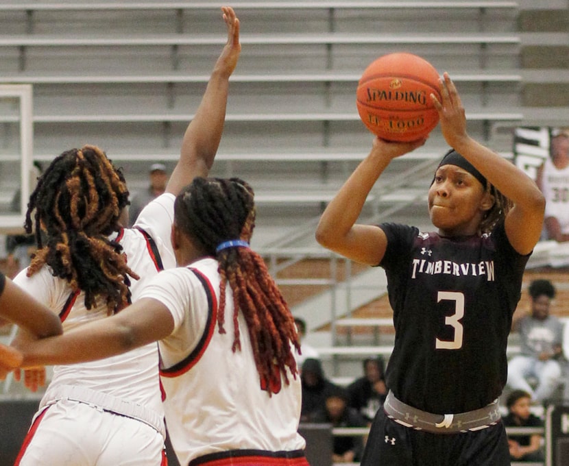 Mansfield Timberview point guard Desiree Wooten (3) sinks a 3-pointer over the defense of...