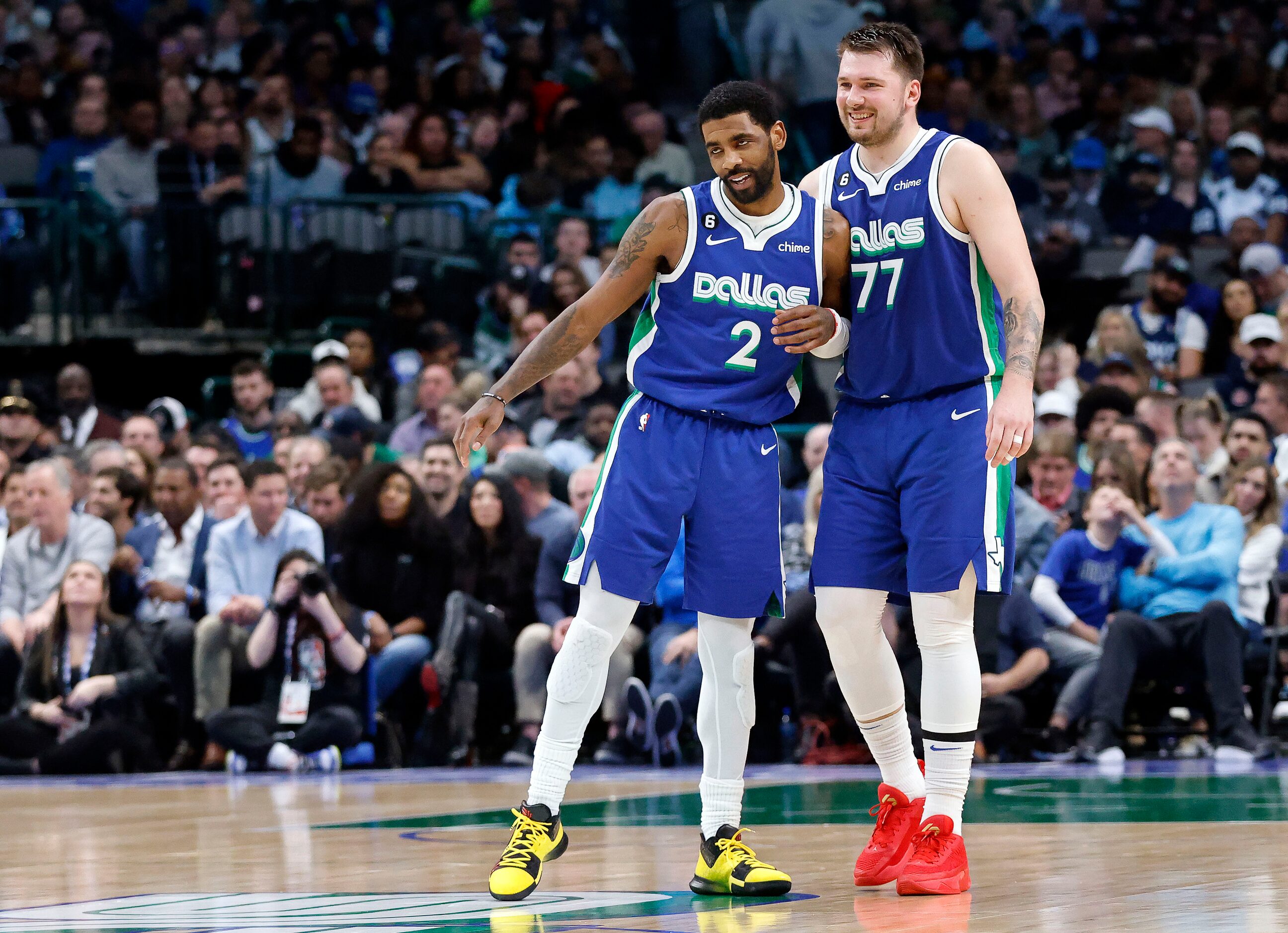 Dallas Mavericks guards Kyrie Irving (2) and Luka Doncic (77) bump shoulders following a...