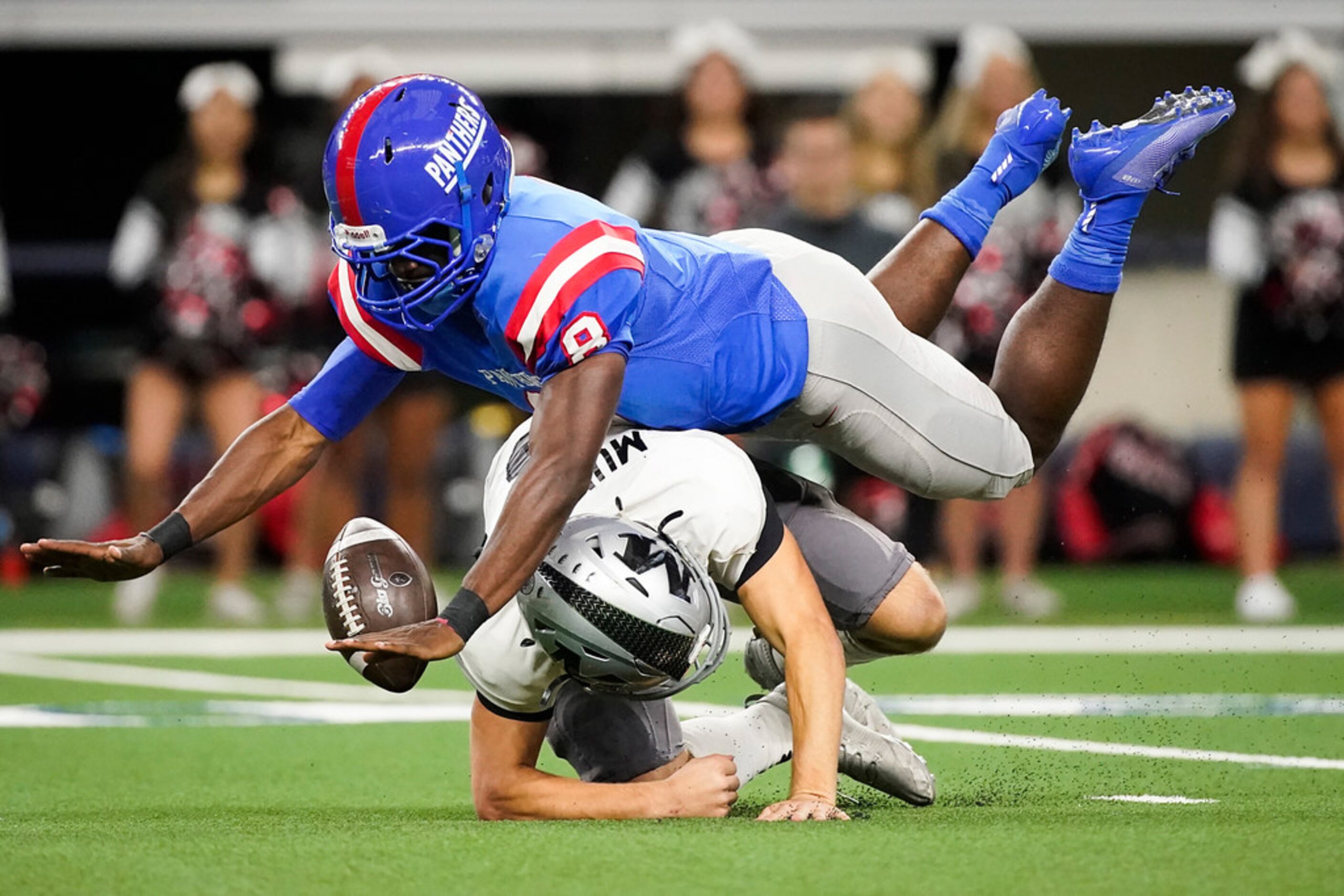 Arlington Martin quarterback Zach Mundell fumbles as he is hit by Duncanville linebacker...