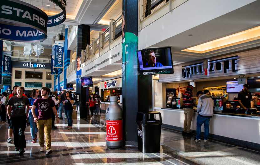 Guests pass by concession stands before an NBA game between the Dallas Mavericks and the...