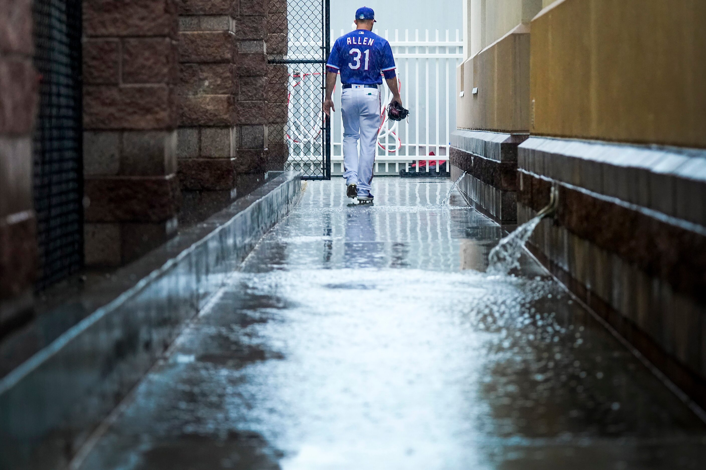 Texas Rangers pitcher Cody Allen heads from the clubhouse to the indoor batting cage for a...