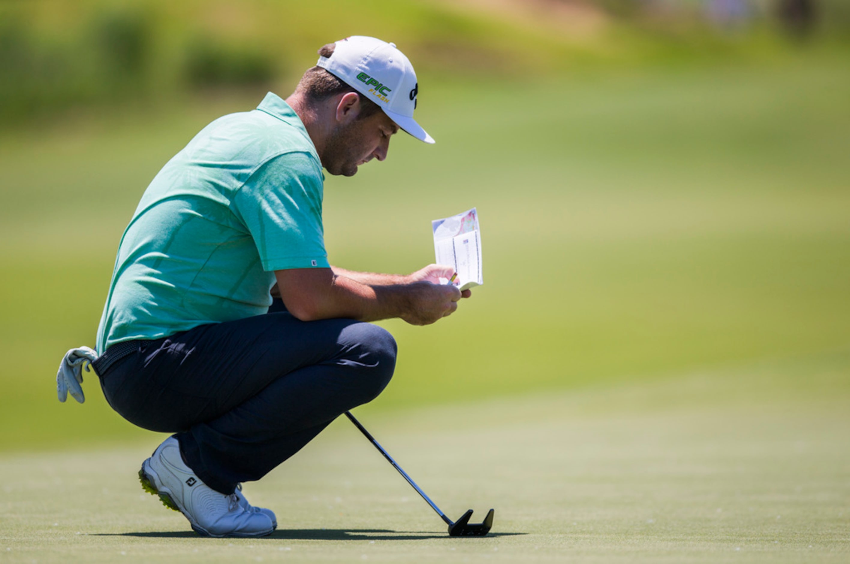 Matt Every looks at his score card on the third green during round 4 of the AT&T Byron...