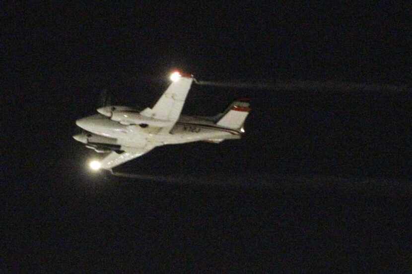 A Beechcraft airplane sprayed insecticide over a Dallas neighborhood to curb the spread of...