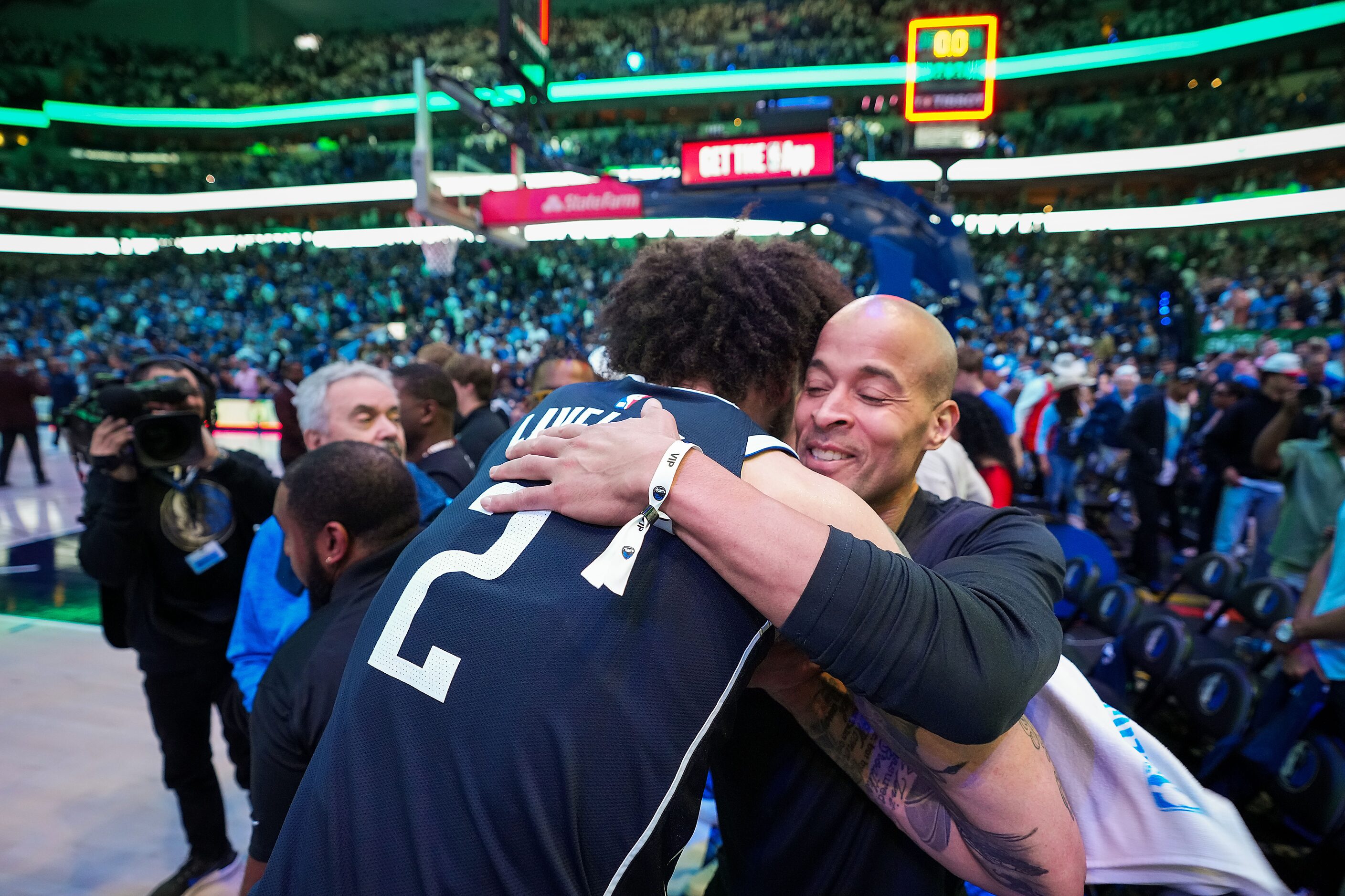 Dallas Mavericks center Dereck Lively II hugs David Goggins after a victory over the...